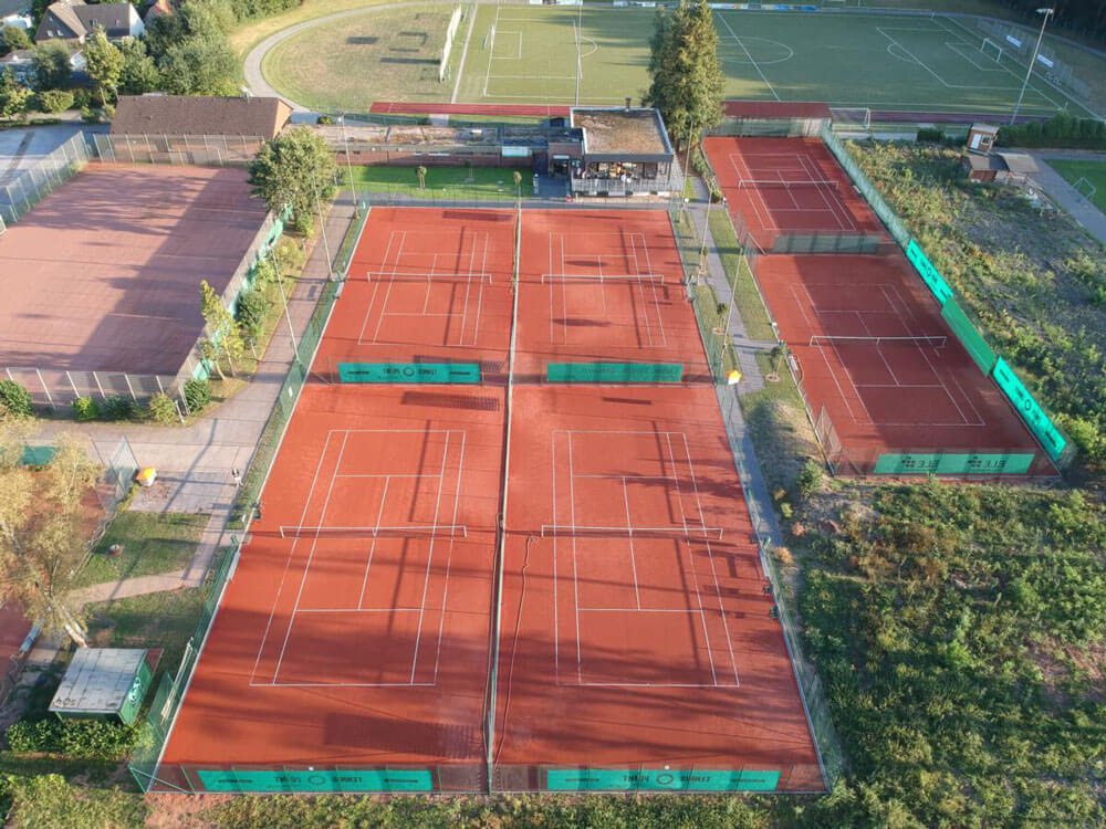 Luftbild der Tennisanlage des VfL Grafenwald bei Tageslicht mit neu positionierten Lichtmasten.